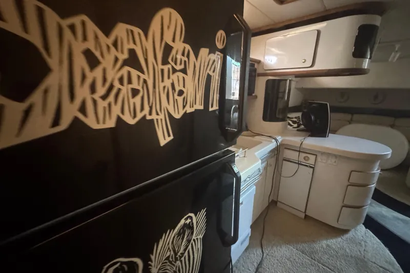 Slide: The Image of Interior of 1995 Sea Ray 500 Sundancer yacht with modern kitchen and unique decor. - 14