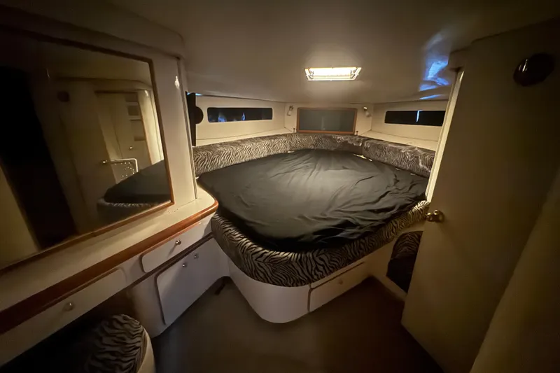 Slide: The Image of Cozy cabin interior of 1995 Sea Ray 500 Sundancer with zebra-patterned bedding. - 15