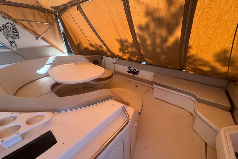 Slide: The Image of 1995 Sea Ray 500 Sundancer interior with seating and table under canopy. - 16