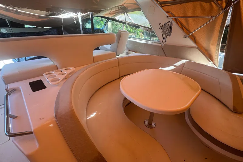 Slide: The Image of 1995 Sea Ray 500 Sundancer interior with curved seating and table. - 17