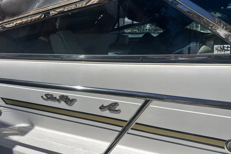 Slide: The Image of 1995 Sea Ray 500 Sundancer boat with sleek design and logo detail. - 2