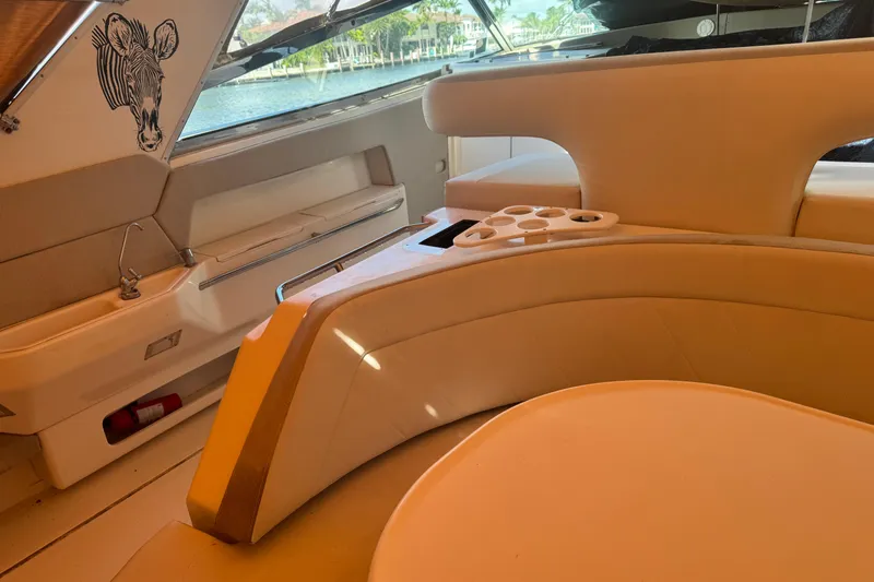 Slide: The Image of Luxurious interior of 1995 Sea Ray 500 Sundancer yacht with plush seating and cup holders. - 20