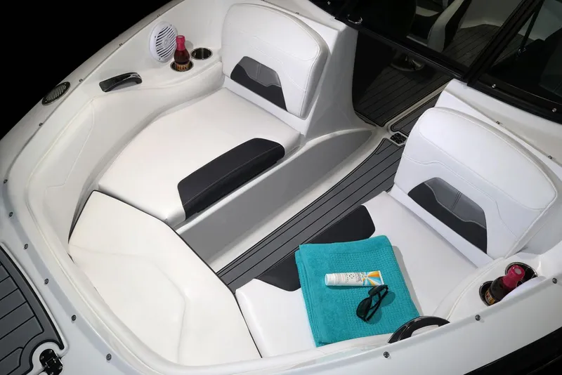 Slide: The Image of 2023 Monterey 224FS boat interior with cushioned seating and wood-style flooring. - 4