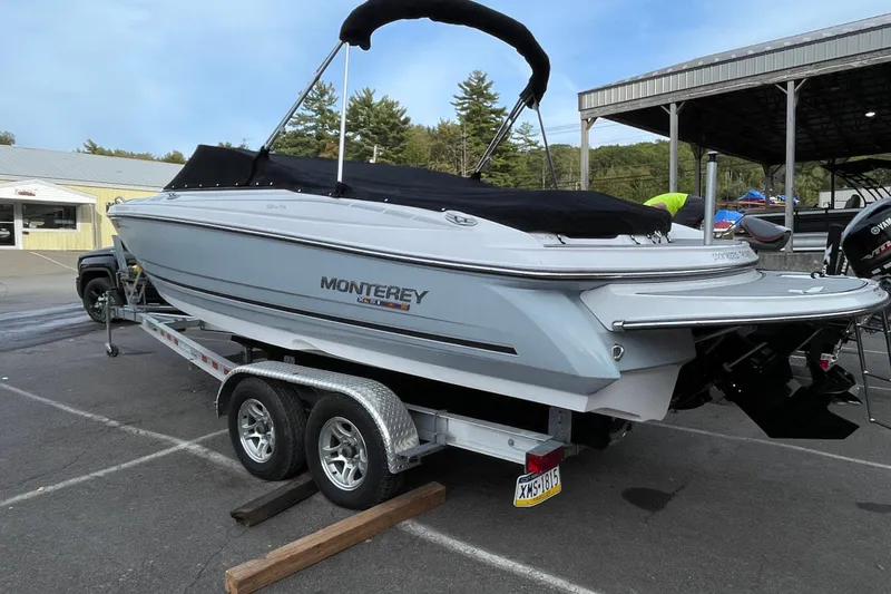 Slide: The Image of 2023 Monterey 224FS boat on trailer, covered and parked outdoors. - 9