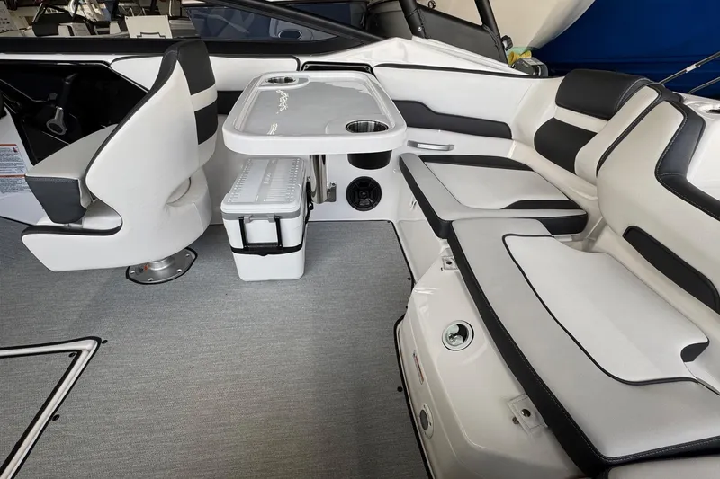 Slide: The Image of 2026 Yamaha Boats AR195 interior with seating, table, and storage. - 13