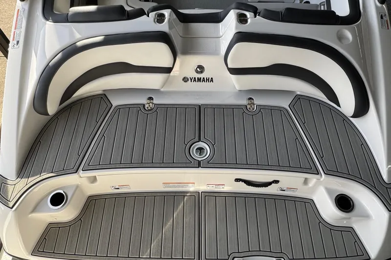 Slide: The Image of 2026 Yamaha Boats AR195 swim platform with cushioned seating and sleek design. - 15