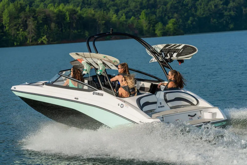 Slide: The Image of 2026 Yamaha Boats AR195 interior view in showroom, featuring sleek seating and modern design. - 2