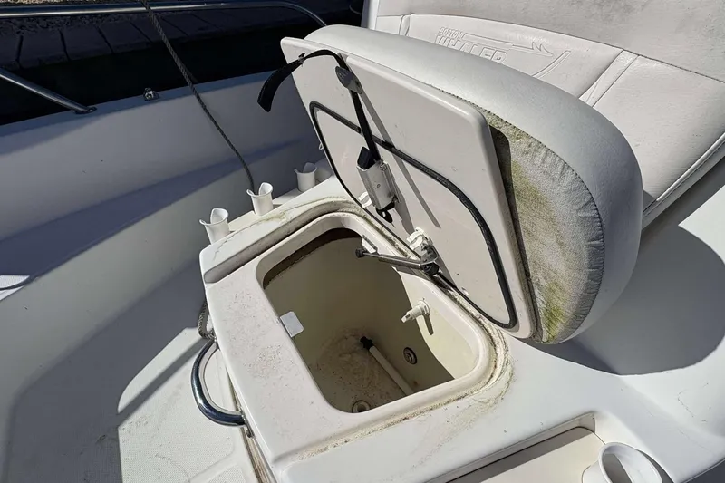 Slide: The Image of Open storage compartment on 2011 Boston Whaler 180 Dauntless boat, showing interior details. - 12