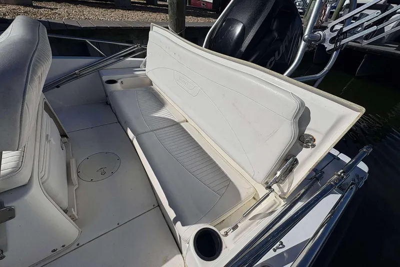 Slide: The Image of 2011 Boston Whaler 180 Dauntless boat interior with white seating and storage compartment. - 14