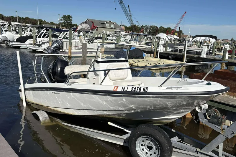 Slide: The Image of 2011 Boston Whaler 180 Dauntless boat on trailer at marina dock. - 7