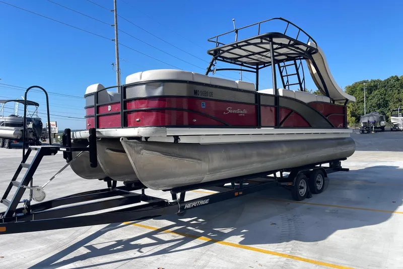 Slide: The Image of 2017 Godfrey Sweetwater 255 pontoon boat on trailer, parked outdoors. - 10