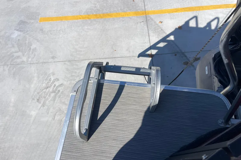 Slide: The Image of 2017 Godfrey Sweetwater 255 boat ladder on deck, parked on concrete surface. - 12