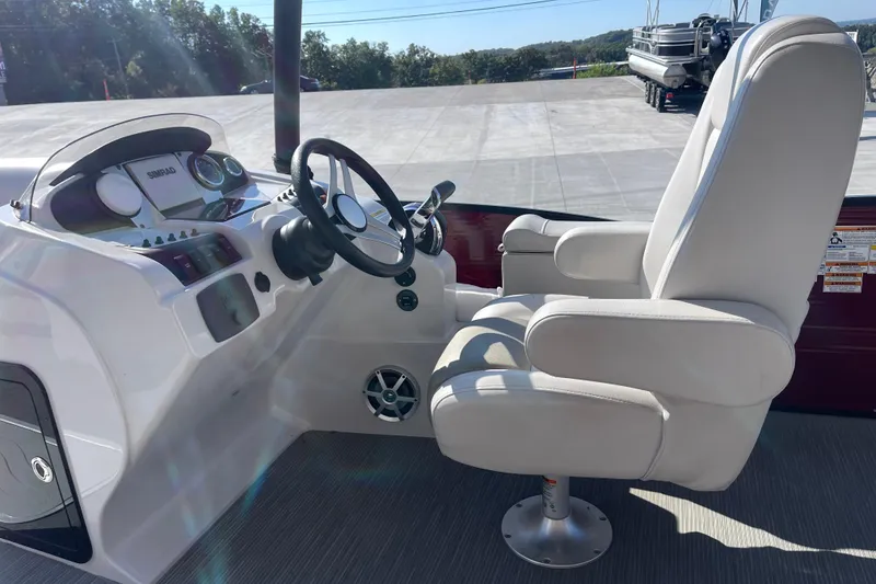Slide: The Image of 2017 Godfrey Sweetwater 255 boat helm with steering wheel and captain's chair. - 15