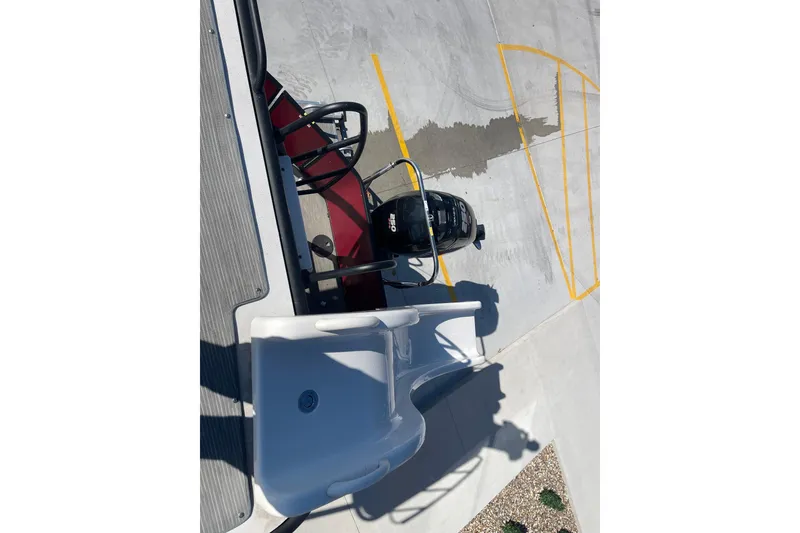 Slide: The Image of 2017 Godfrey Sweetwater 255 boat with slide and motor, parked on concrete surface. - 21