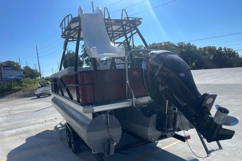 Slide: The Image of 2017 Godfrey Sweetwater 255 pontoon boat with slide and outboard motor in parking lot. - 6
