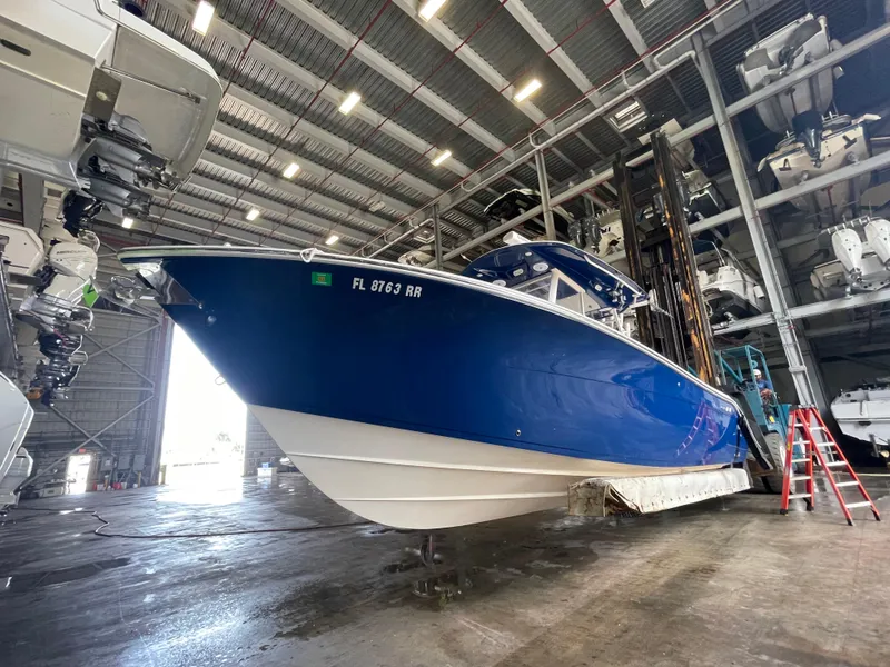 The Image of 2018 Cobia 301 Center Console boat in storage facility. - 0