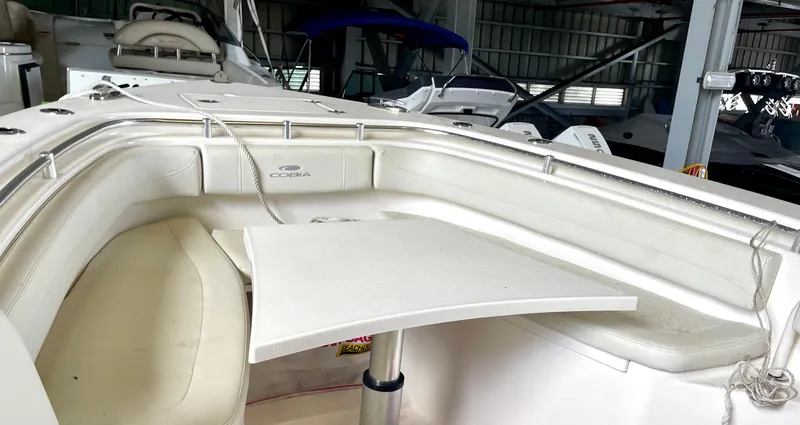 Slide: The Image of 2018 Cobia 301 Center Console boat interior with seating and table. - 10