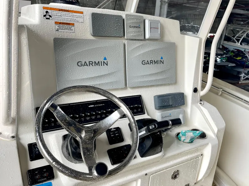 Slide: The Image of 2018 Cobia 301 Center Console helm with Garmin navigation system. - 13