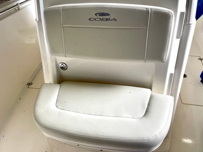 Slide: The Image of 2018 Cobia 301 Center Console boat seat with logo. - 14