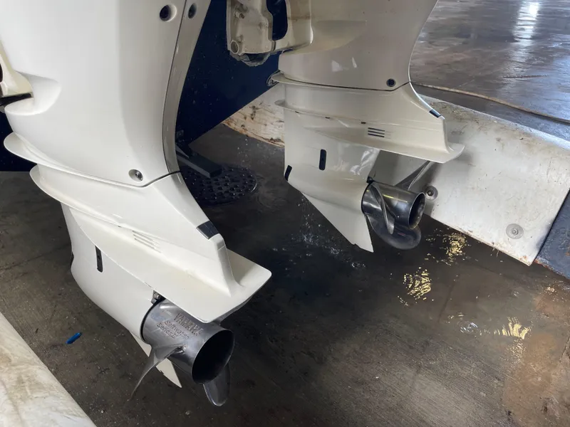 Slide: The Image of Twin outboard motors on a 2018 Cobia 301 Center Console boat. - 18