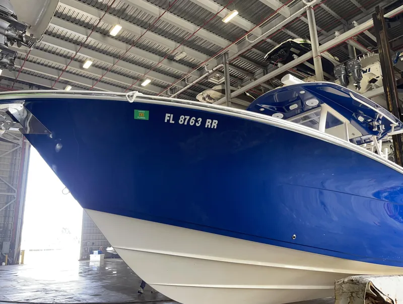 Slide: The Image of 2018 Cobia 301 Center Console boat in a storage facility. - 3