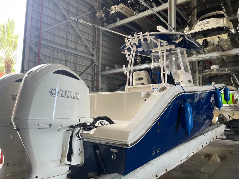 Slide: The Image of 2018 Cobia 301 Center Console boat with Yamaha engines in storage. - 5