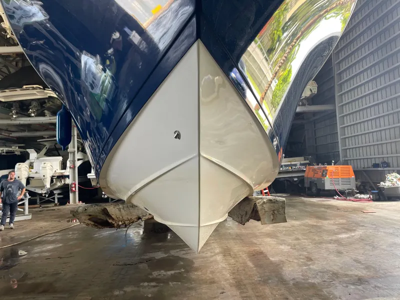 Slide: The Image of 2018 Cobia 301 Center Console boat in a storage facility. - 7