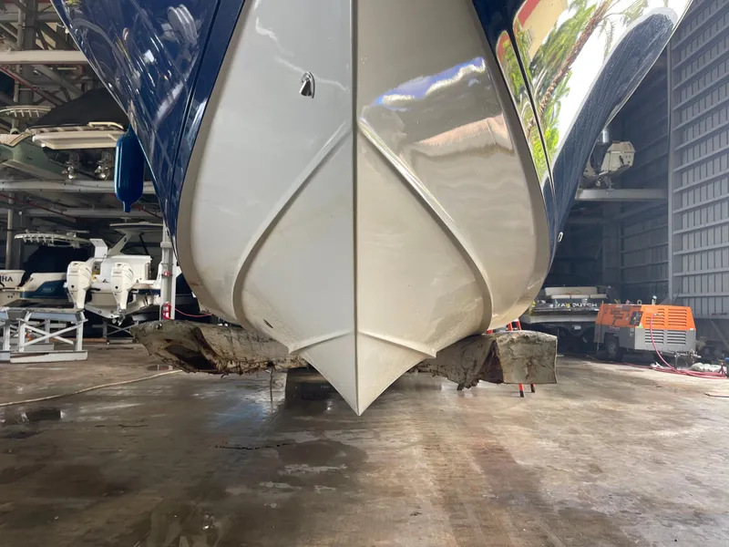 Slide: The Image of 2018 Cobia 301 Center Console boat in storage facility, hull view. - 8