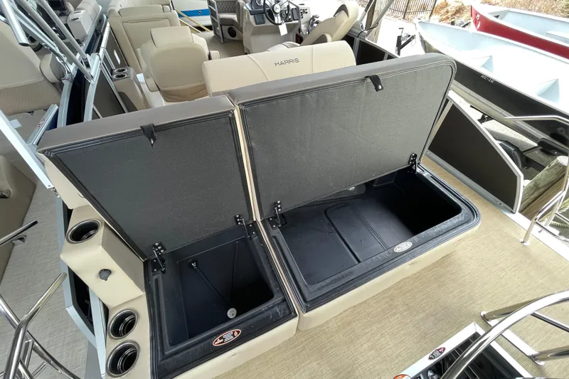 Slide: The Image of 2026 Harris Cruiser 210 boat interior with open storage compartments and seating. - 10