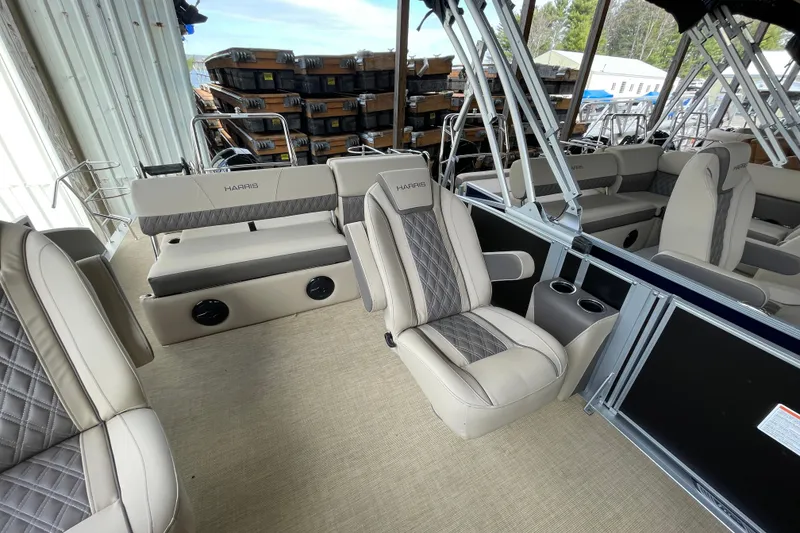 Slide: The Image of 2026 Harris Cruiser 210 pontoon boat interior with beige seating and cup holders. - 12