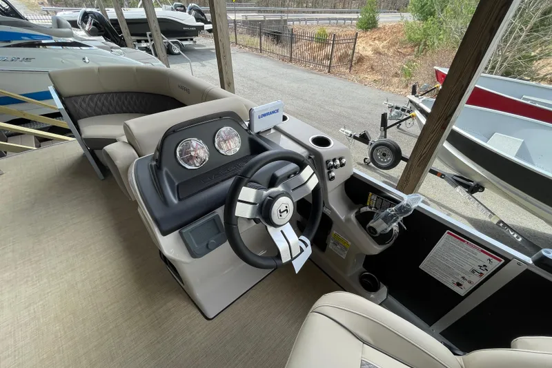 Slide: The Image of Interior view of 2026 Harris Cruiser 210 boat with steering wheel and dashboard. - 14