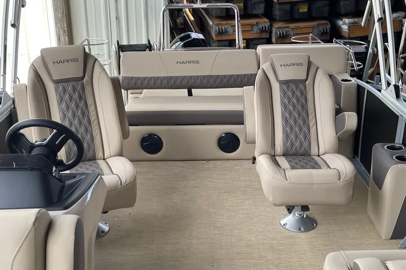 Slide: The Image of 2026 Harris Cruiser 210 boat interior with beige seating and steering wheel. - 4