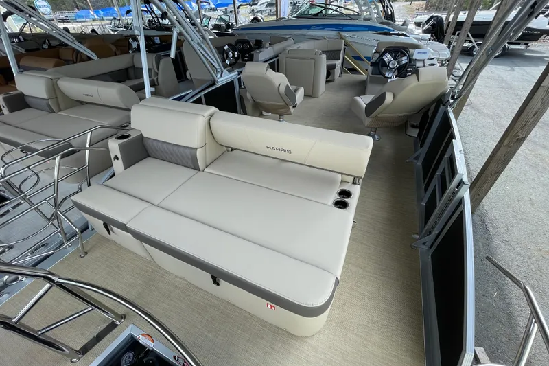 Slide: The Image of 2026 Harris Cruiser 210 pontoon boat interior with beige seating and modern helm. - 5