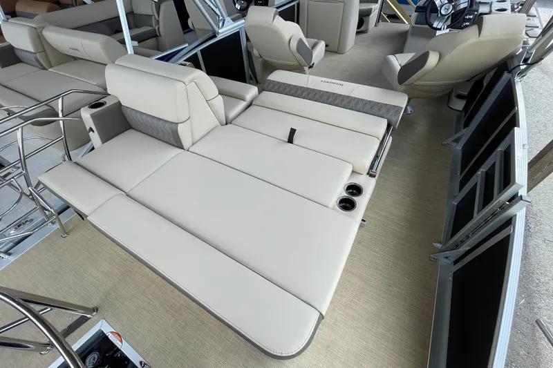 Slide: The Image of 2026 Harris Cruiser 210 boat interior with beige seating and cup holders. - 7