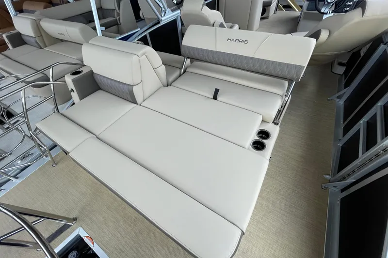 Slide: The Image of 2026 Harris Cruiser 210 boat interior with beige seating and cup holders. - 8