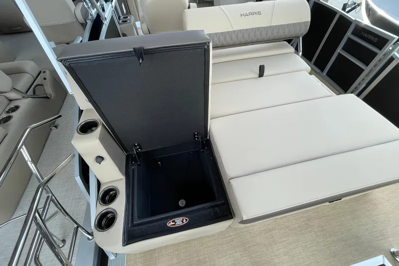 Slide: The Image of 2026 Harris Cruiser 210 boat interior with open storage compartment and cup holders. - 9
