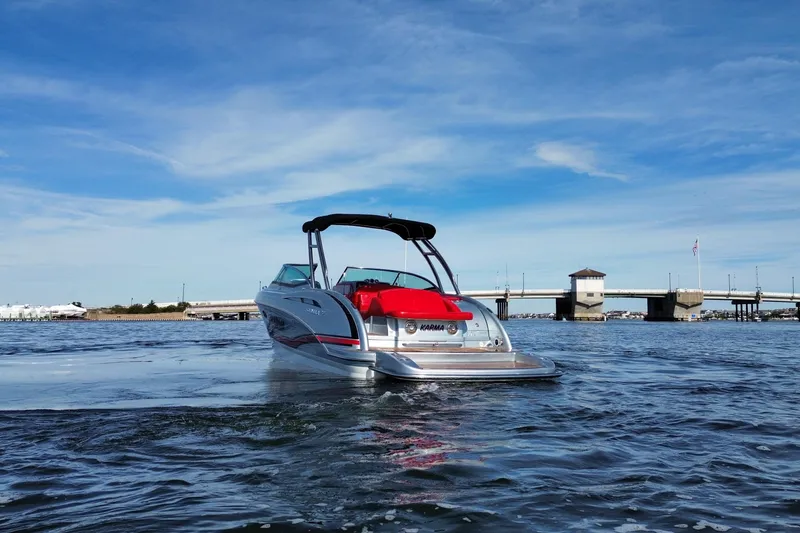 Slide: The Image of 2014 Formula 310 Bowrider on water near a bridge under a clear blue sky. - 13
