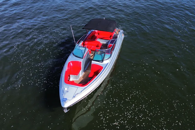 Slide: The Image of 2014 Formula 310 Bowrider with red seating, cruising on open water. - 18