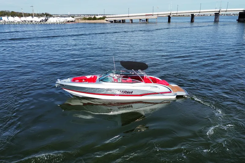 Slide: The Image of 2014 Formula 310 Bowrider boat on calm water near a bridge. - 19