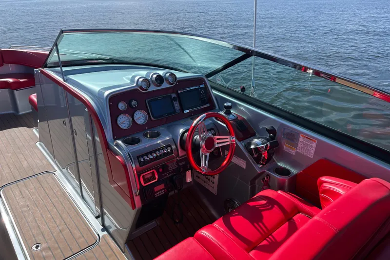 Slide: The Image of 2014 Formula 310 Bowrider boat interior with red seating and modern dashboard controls. - 20