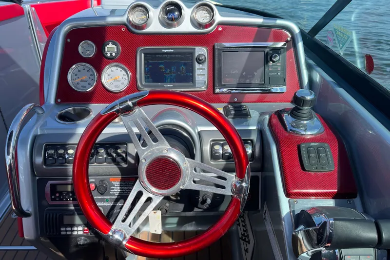 Slide: The Image of 2014 Formula 310 Bowrider dashboard with red steering wheel and navigation controls. - 21