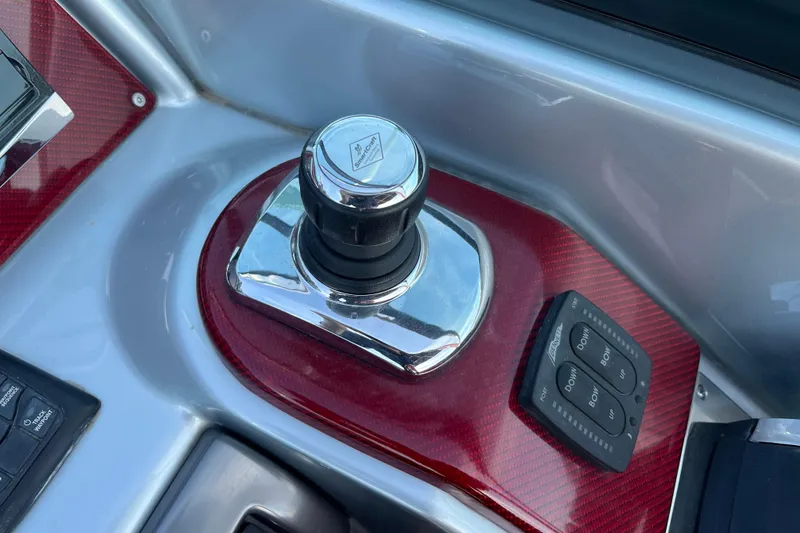 Slide: The Image of 2014 Formula 310 Bowrider joystick control and trim tab buttons on dashboard. - 22