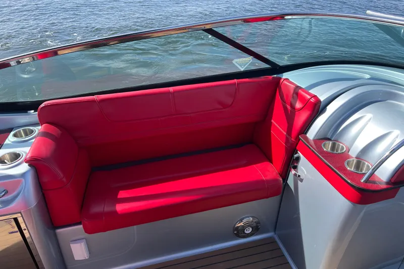 Slide: The Image of Red seating on 2014 Formula 310 Bowrider boat, with cup holders, by the water. - 24