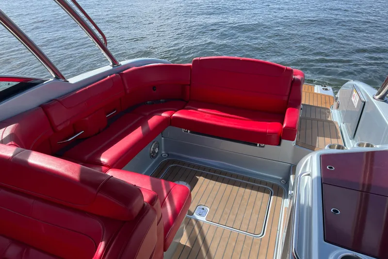 Slide: The Image of 2014 Formula 310 Bowrider with red seating and teak flooring on the water. - 25