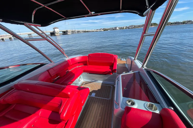 Slide: The Image of 2014 Formula 310 Bowrider with red seating, docked on a sunny day. - 26