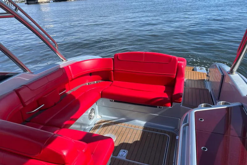 Slide: The Image of 2014 Formula 310 Bowrider with vibrant red seating, docked on calm water. - 27