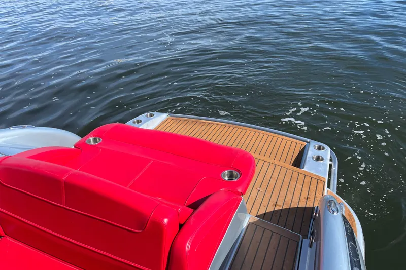 Slide: The Image of Red seating and teak deck of a 2014 Formula 310 Bowrider on water. - 28