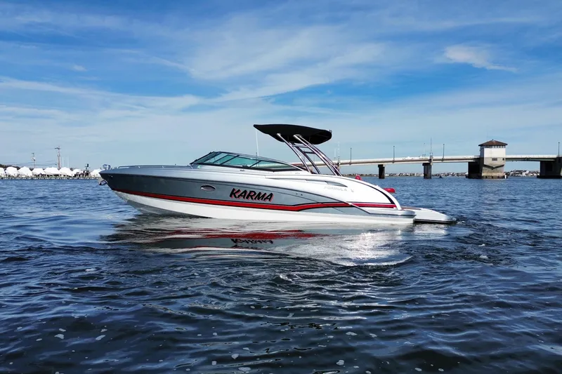 Slide: The Image of 2014 Formula 310 Bowrider boat on water, clear sky, bridge in background. - 3