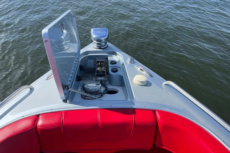 Slide: The Image of 2014 Formula 310 Bowrider with open anchor hatch, red seating, on calm water. - 35