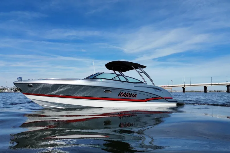 Slide: The Image of 2014 Formula 310 Bowrider boat on water under blue sky. - 9